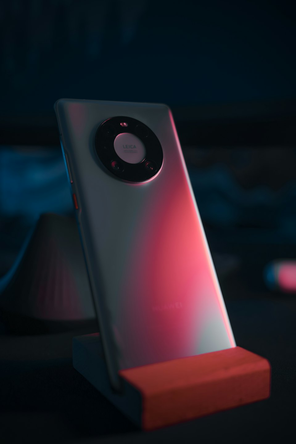 Smartphone with multi-camera module on display stand.
